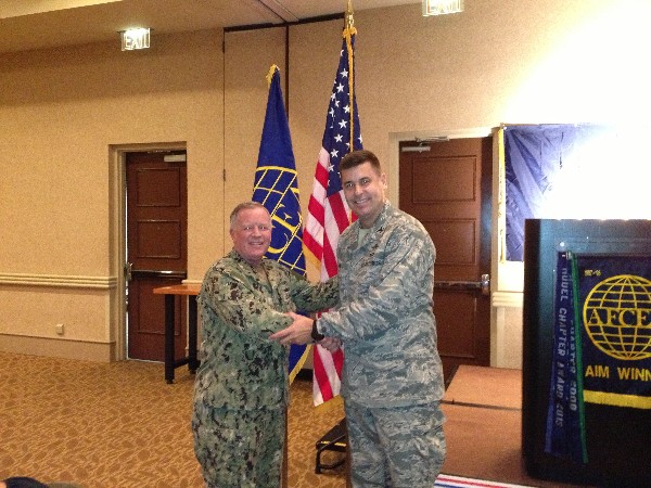 TAMPA-ST. PETERSBURG— Capt. Gerry Slevin, USN, chapter president (l), greets Col. Michael Hill, USAF, deputy director, communications systems, J-6 for Headquarters, United States Special Operations Command, speaker for the July luncheon.
